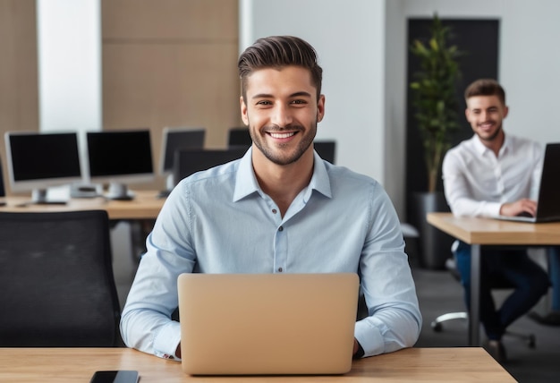 A man smiling while working on his laptop at the office he appears relaxed and satisfied with his