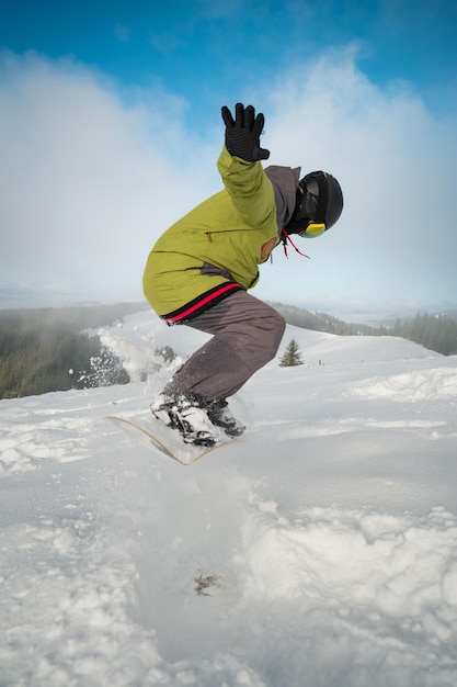 Man snowboarder portrait carpathian mountains on background