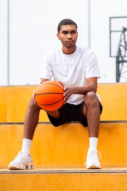 Man in sportswear sitting after the game with an upset look