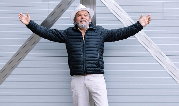 A man standing by an automatic gate at his own house returning home from work