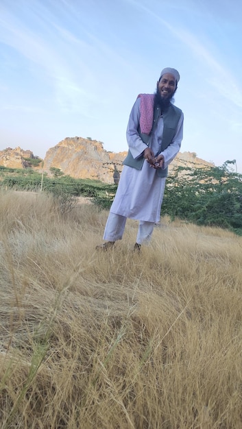 Man standing on field against sky