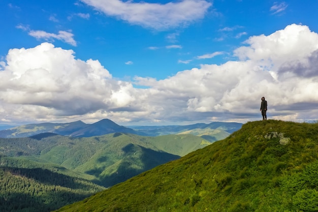 The man standing on the mountain with a picturesque view