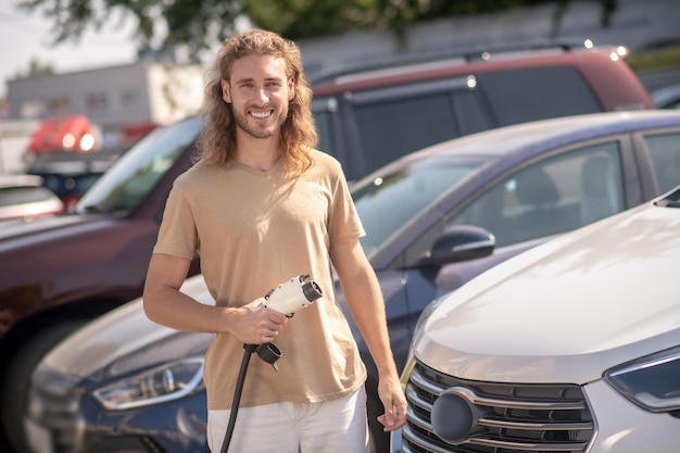 Man standing near car smiling at camera