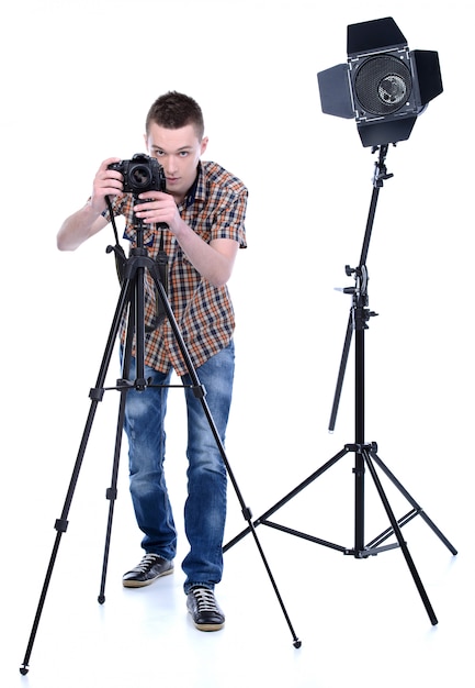 A man stands behind the camera