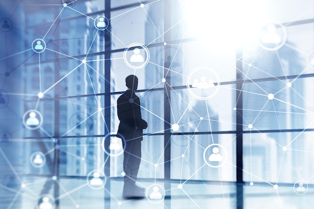 A man stands in front of a glass wall with the words'social media'on it