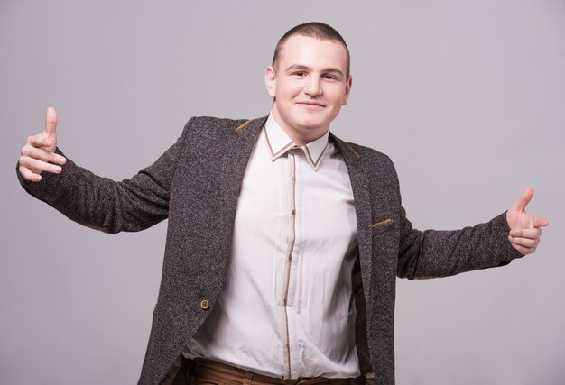 A man stands in a suit and smiles.