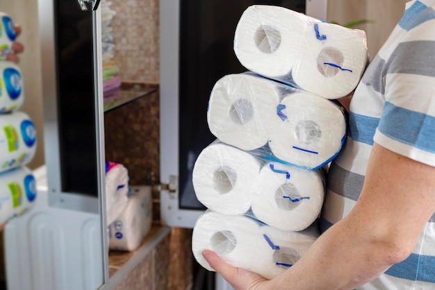 A man stocking up toilet paper at home