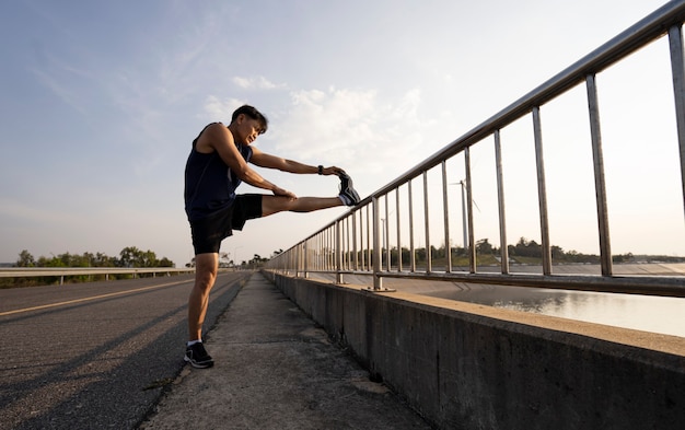 Man stretches the body before running. Fitness, jogging, running, exercise, lifestyle and healthy concept.
