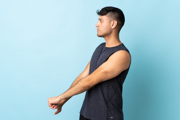 Man stretching arms in studio