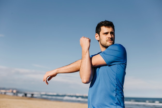 Man stretching at the beach