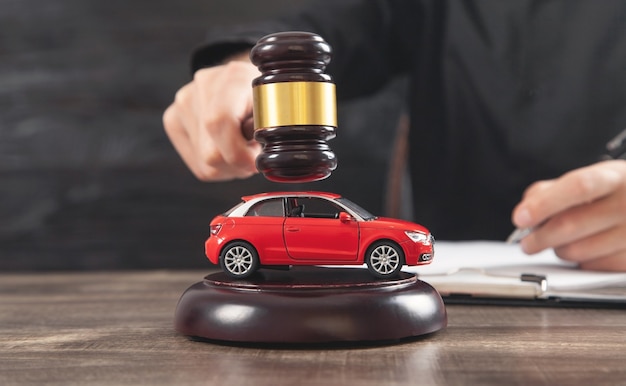 Man striking the gavel over car. Car auction