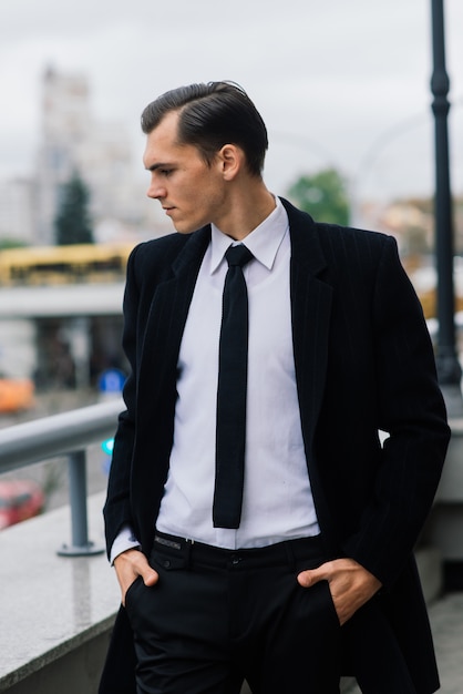 Man in a stylish suit. Businessman in an autumn city, fashion