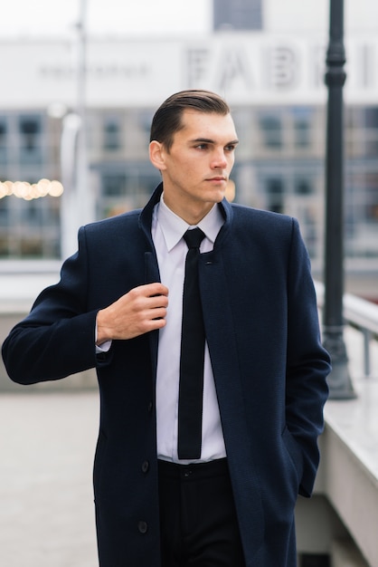 Man in a stylish suit posing outdoors