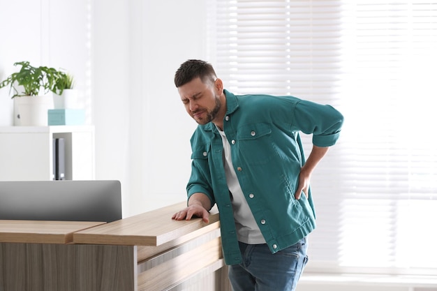 Man suffering from back pain in office Bad posture problem