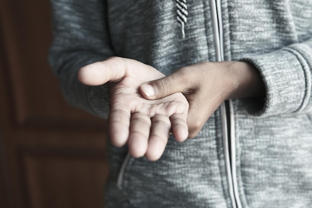 Man suffering pain in hand close up