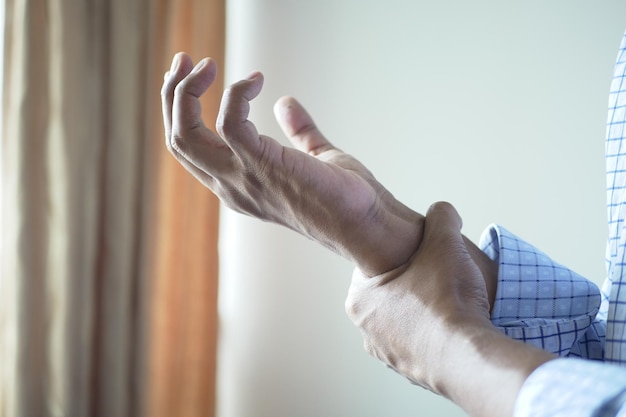 Man suffering pain in hand close up