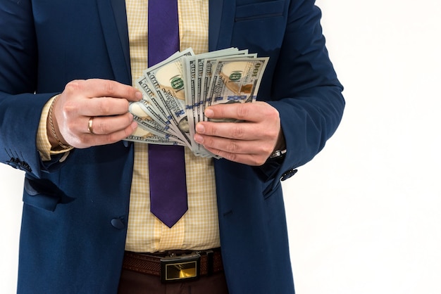 Man in suit hold many us money dollar, isolated on white