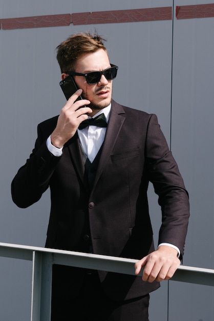 A man in a suit is talking on the phone.