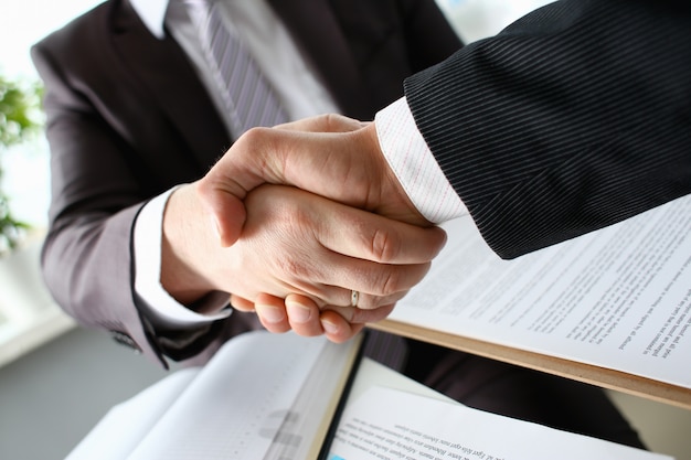 Man in suit shake hand as hello in office