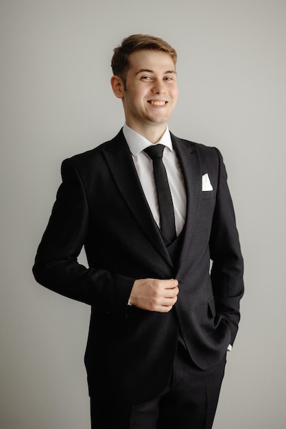 A man in a suit smiles for the camera.