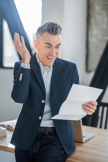 A man in a suit with documents in hands