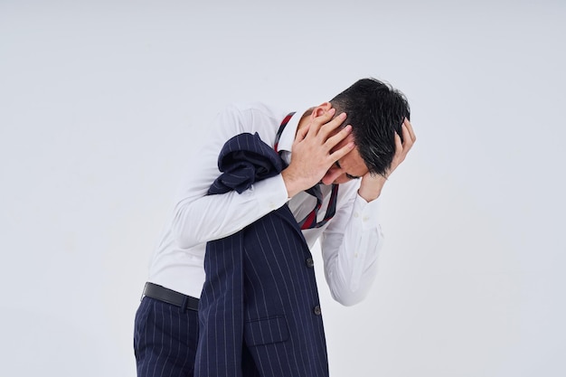 A man in a suit with a stressed expression