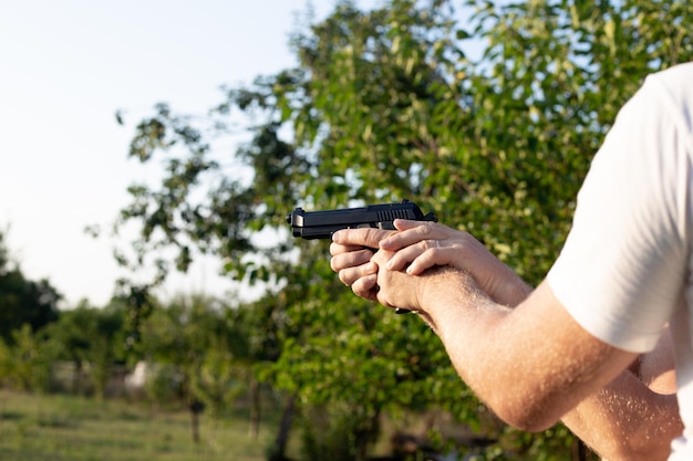 The man supports the hands of another man in which the gun Pistol shooting training Recreation and hobby