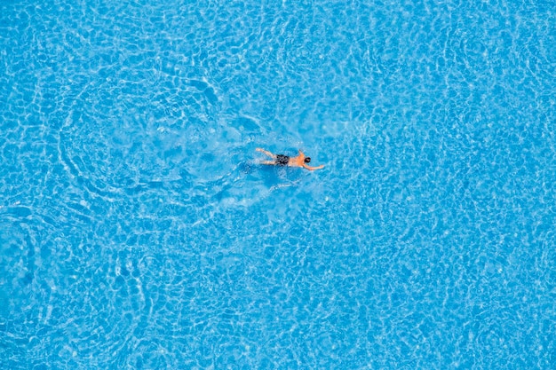 Man swimming in a pool top view