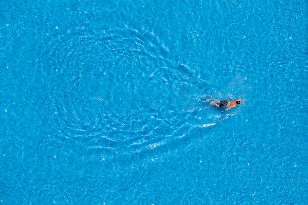 Man swimming in a pool top view