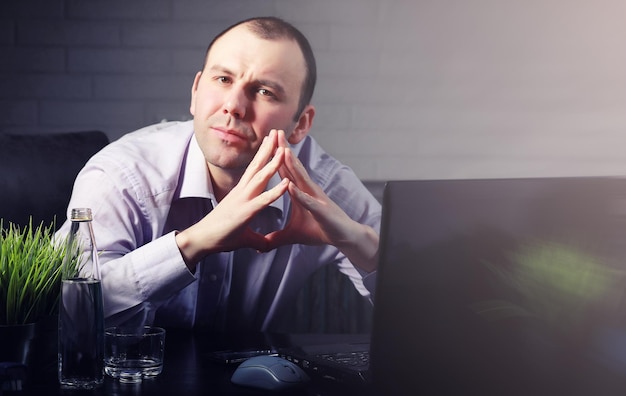 Man at table and working on laptop