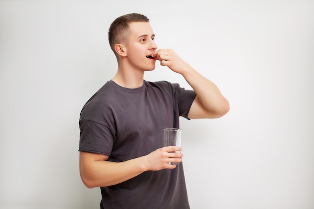 Man takes a pill of amino acids after training.