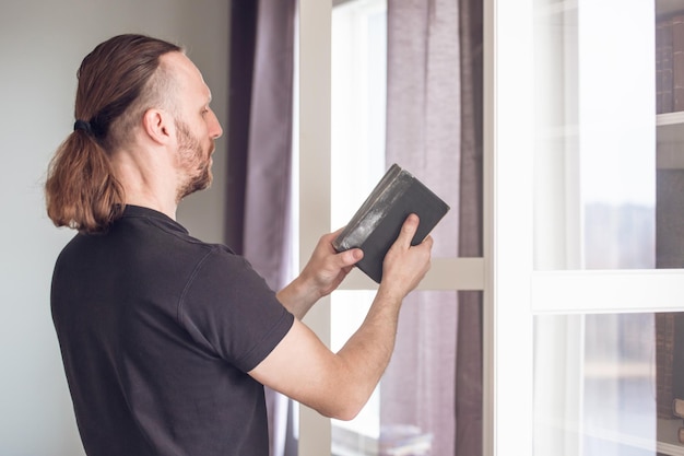 Man taking book from shelf