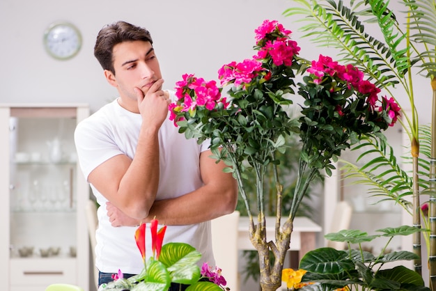 Man taking care of plants at home