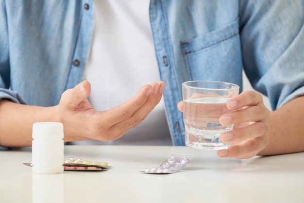 Man taking his pills on couch in the living room