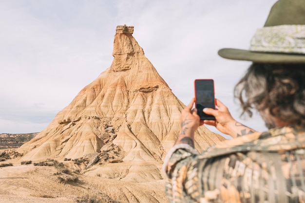 Man Taking A Photo Of Castil De Tierra Which Is A Geological Formation In Spain