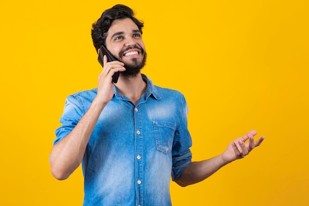 Man talking on cell phone in ear Boy talking on the phone gesturing