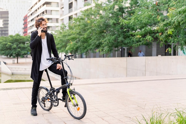 Man talking on his phone while sitting on his bike