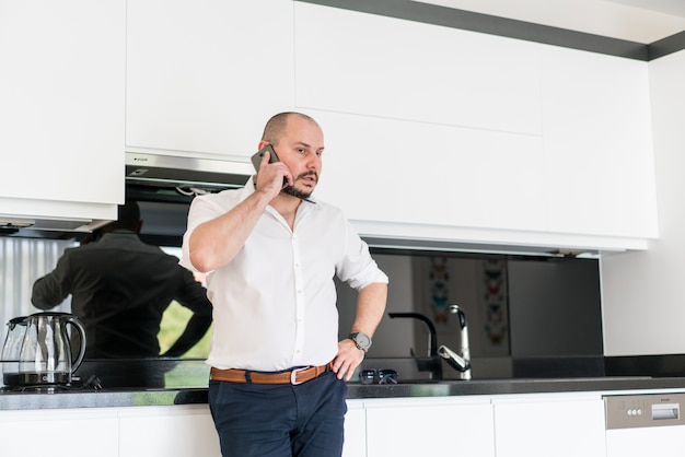 Man talking on phone in fancy hotel apartment