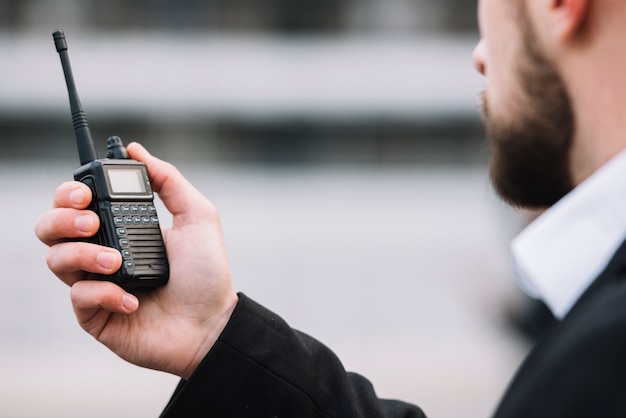 Man talking throu security walkie talkie