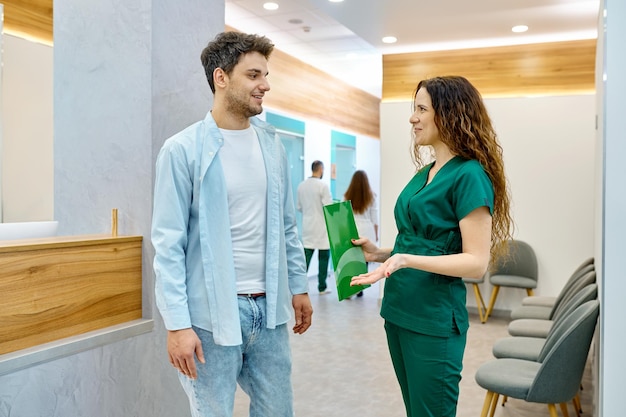 Man talking with doctor in clinic hall