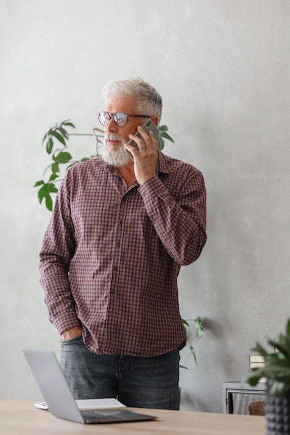 Man talks on the phone with colleagues or business partners solving financial and legal problems