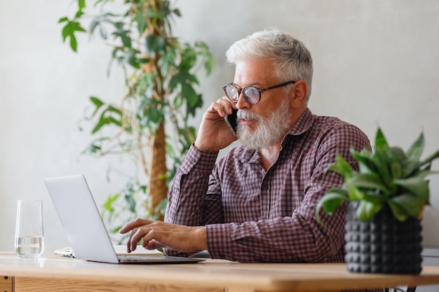 Man talks on the phone with colleagues or business partners solving financial and legal problems