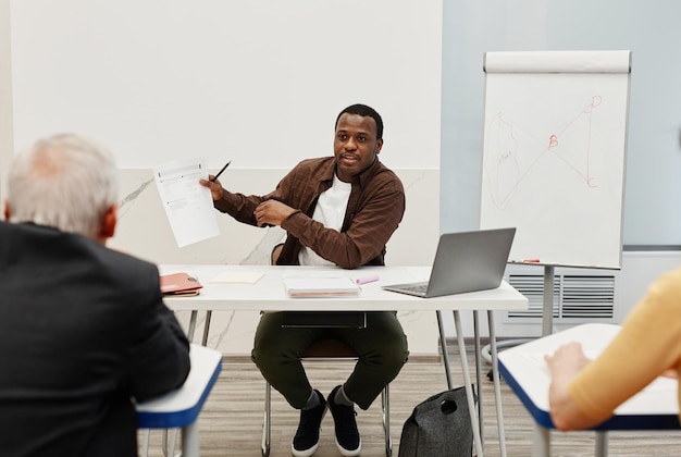 Man teaching people at training