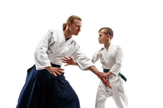 Man and teen boy fighting at aikido training in martial arts school