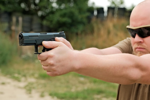 A man threatens with a combat pistol man holding a gun in his hands