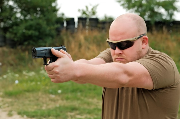 A man threatens with a combat pistol man holding a gun in his hands