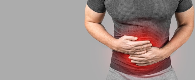 Man touching stomach suffering painful of stomachache gastrointestinal system desease cause of stress from workHealth insurance care concept bowel disease concept heartburn copy space