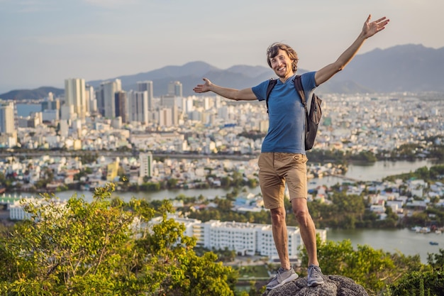 Man tourist on the background of Nha Trang city Travel to Vietnam Concept