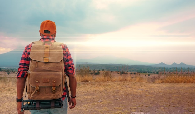 Man Traveler with backpack mountaineering