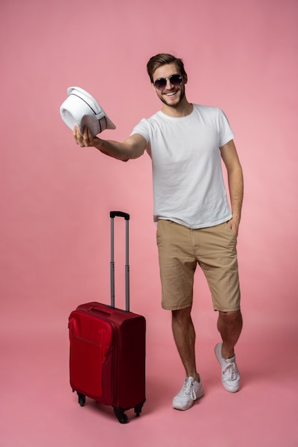 Man traveler with suitcase, passport and ticket.